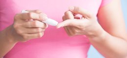 Teen performing glucose monitoring