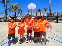 Eli with friends on a basketball court