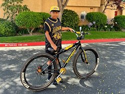 Eli posing with his bike