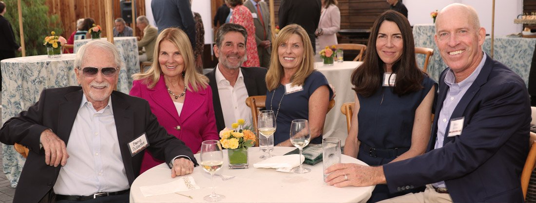 Cottage board members and donors seated at an event