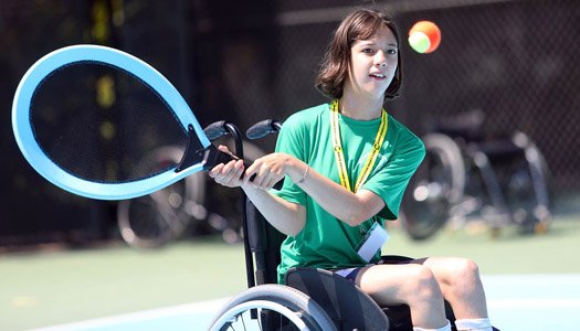 Jr. Wheelchair Camp participant playing tennis