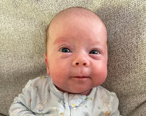 Newborn smiling at the camera