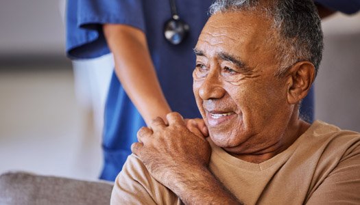 Male patient holding the hand of a provider