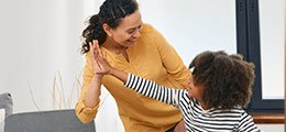 child hi five's her caregiver