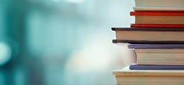 a stack of books on a blue bokeh background