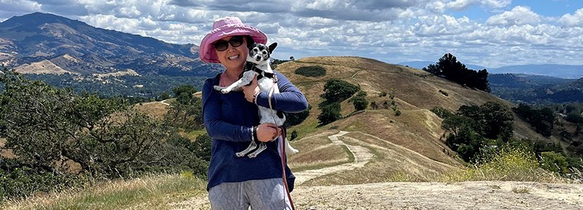 Akiko Noguchi is holding her dog in the mountains