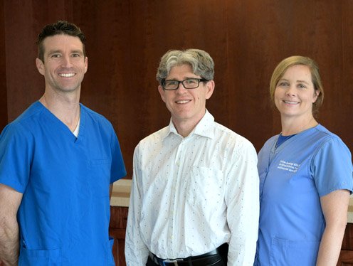 Group of three health professionals posing for a photo