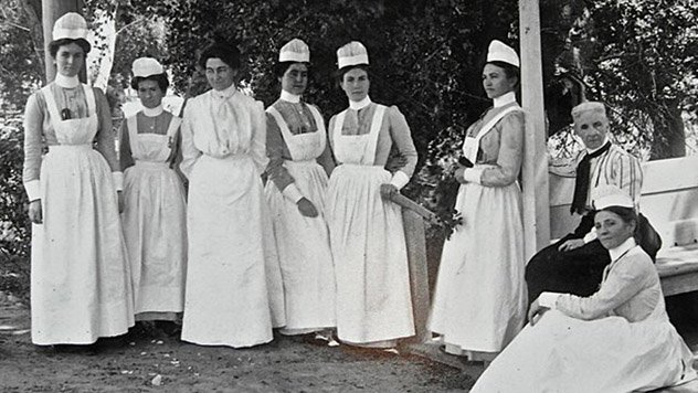 Group of nurses sitting in front of Cottage Hospital circa 1888