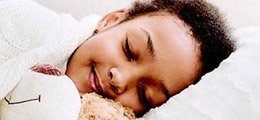 Child sleeping on a bed
