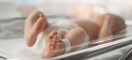 a newborn baby in a hospital crib