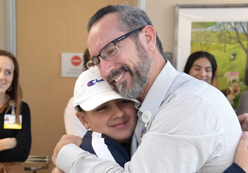 Provider hugging patient on last day of chemotherapy