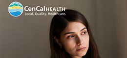 a troubled woman leaning against a wall, cencal health logo superimposed in the top right corner