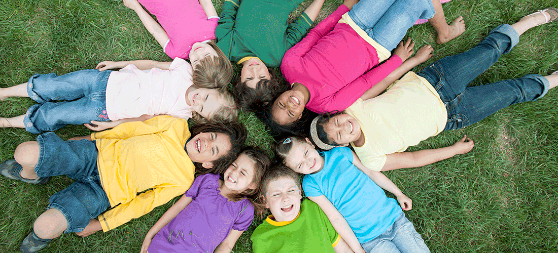 A group of children lying in a circle on the floor
