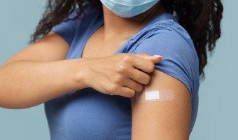 Woman showing a band aid on her arm