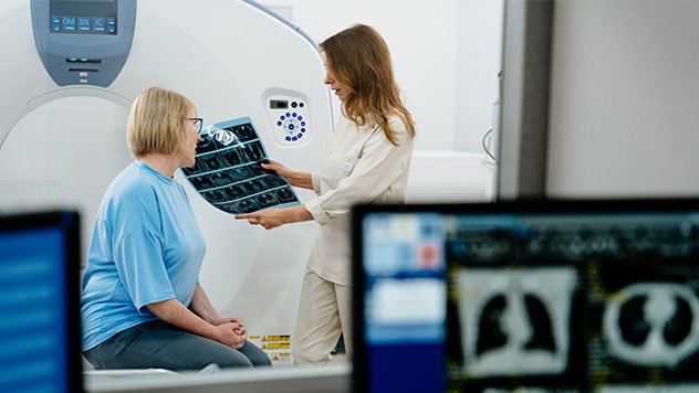 Doctor explains tomography results to mature female patient