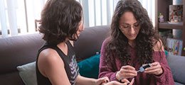a mother and teenage daughter apply a diabetes treatment together