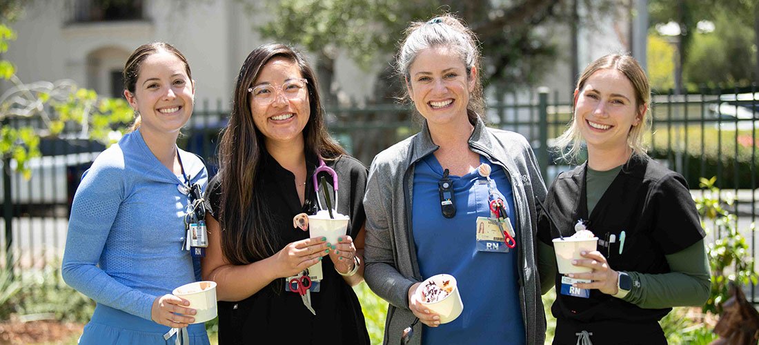 A group of Cottage Nurses outside with cafeteria snacks