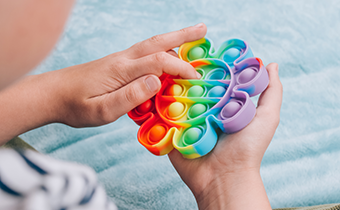 A child playing with a fidget toy