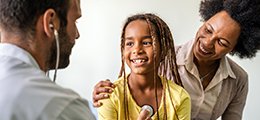 A girl and her mother visiting a doctor