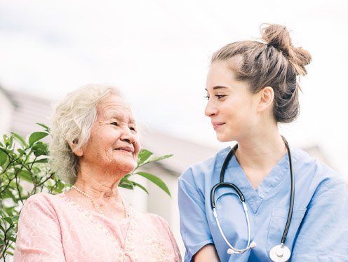 Nurse sitting with a senior female patient