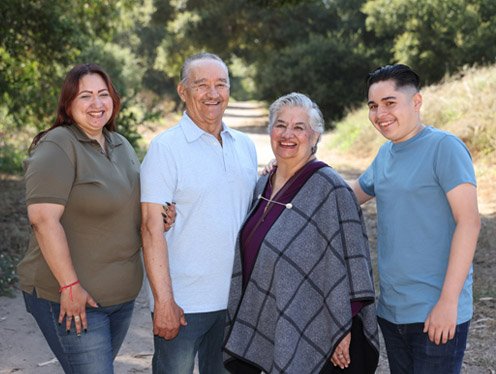 Family posing for a picture standing on a trail