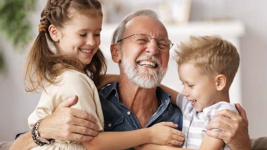 Grandfather hugging his grandkids