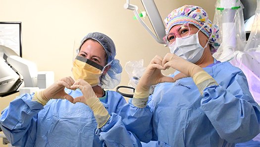 Surgeons in a surgical suite performing a procedure