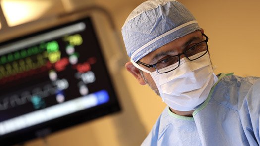 Cottage Heart & Vascular Center Clinic medical provider standing in front of a heart monitor and performing a procedure