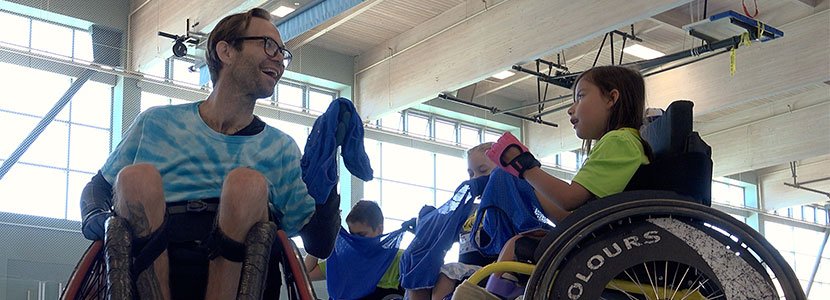 Rugby Coach Kyle McKittrick and young wheelchair athlete playing on the court