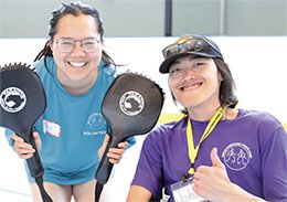 Junior Wheelchair Sports Camp Volunteer and Athlete smiling