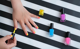 A child putting on nail polish