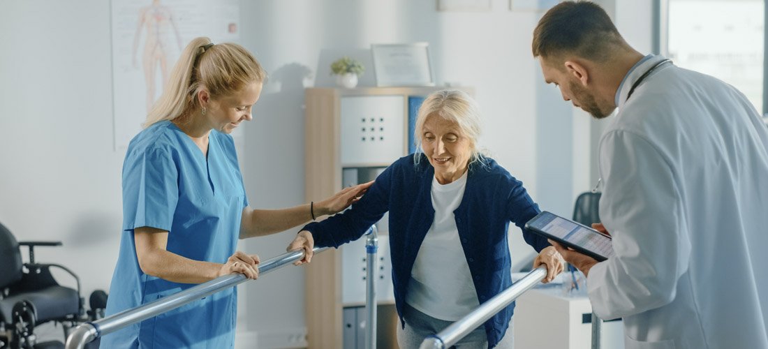 Patient being assisted with walking excercises