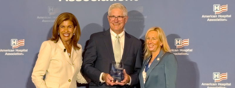 Ron Werft receiving an award on the American Hospital Association stage