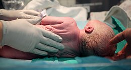 doctors examining a newborn