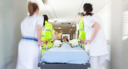 a girl being admitted to the emergency department on a gurney