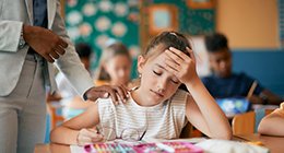 a girl in school with a headache