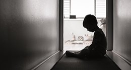 a boy alone in a hallway