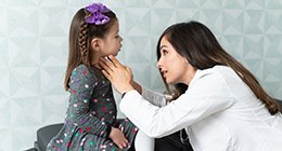 a girl getting her thyroid examined