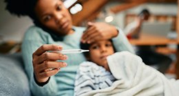 a mother taking her son's temperature