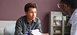 Male teen speaking to a psychiatrist