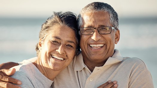 Couple hugging and smiling at the camera