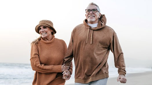 Senior couple walking on the beach