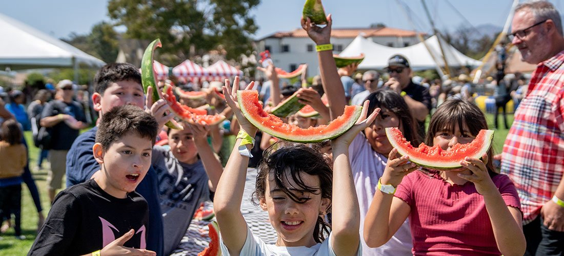 children of Cottage employees competing in a watermelon eating contest at the employee picnic