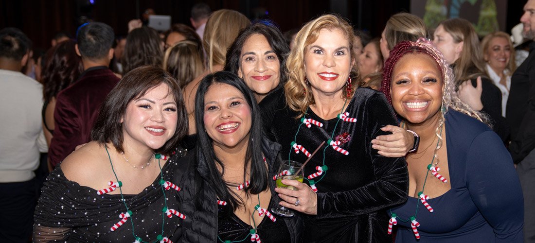 Cottage employees posing and smiling at the Cottage holiday party