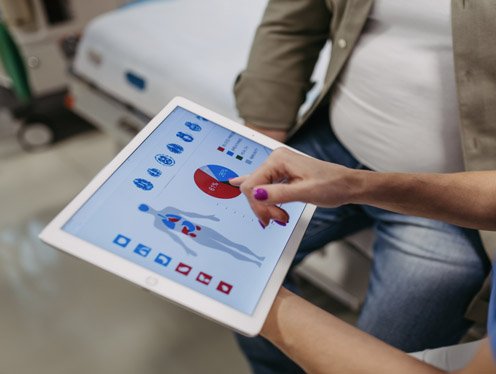 Provider holding a tablet with test results