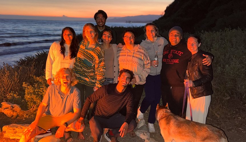 Group of residents enjoying an evening bonfire at the beach