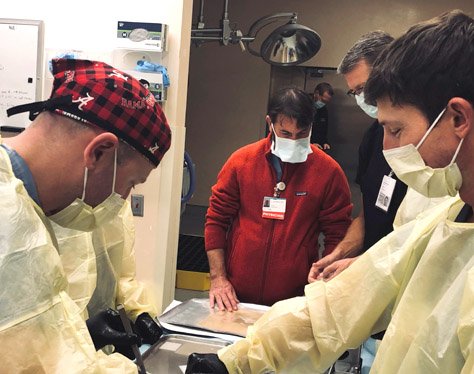 Group of surgeons around a surgical table