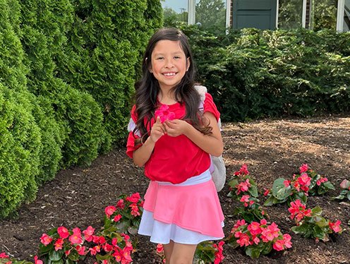 a girl posing in a garden