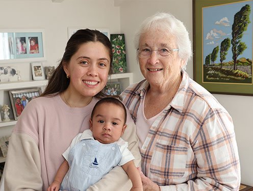 Family posing for a picture in a bedroom