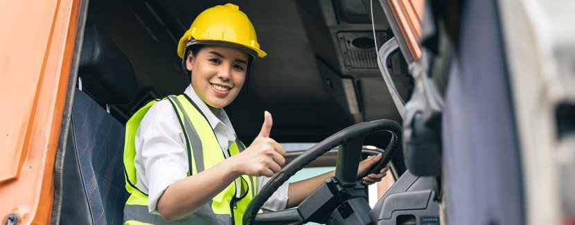 Female truck driver smiling at the camera